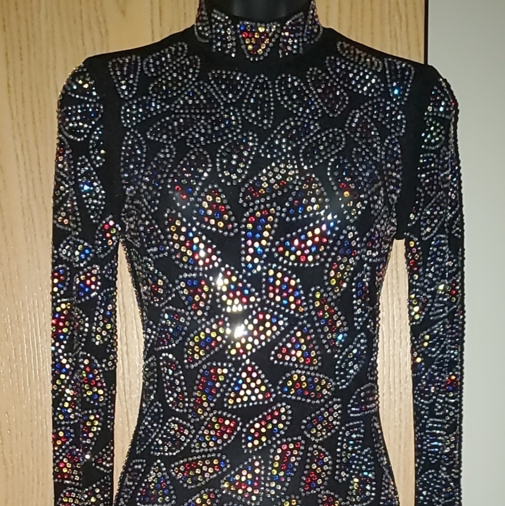 Beautiful dress covered in colored rhinestones .